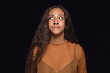 Image showing Close up portrait of young woman isolated on black studio background