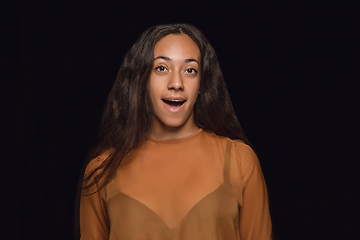 Image showing Close up portrait of young woman isolated on black studio background