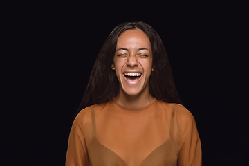 Image showing Close up portrait of young woman isolated on black studio background