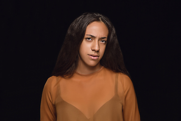 Image showing Close up portrait of young woman isolated on black studio background