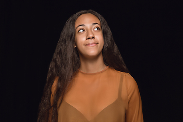 Image showing Close up portrait of young woman isolated on black studio background