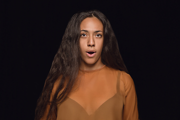 Image showing Close up portrait of young woman isolated on black studio background