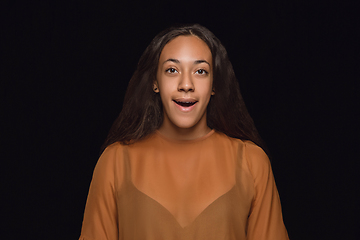 Image showing Close up portrait of young woman isolated on black studio background