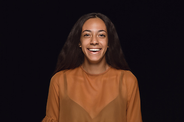 Image showing Close up portrait of young woman isolated on black studio background