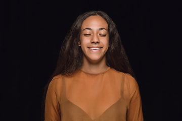 Image showing Close up portrait of young woman isolated on black studio background