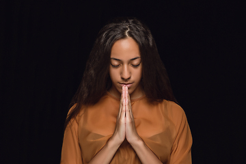 Image showing Close up portrait of young woman isolated on black studio background