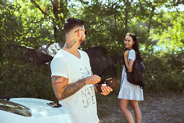 Image showing Young couple preparing for vacation in sunny day