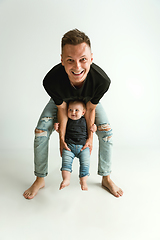 Image showing Happy father holding adorable little son and smiling