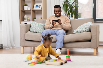 Image showing happy father with tablet pc and baby at home