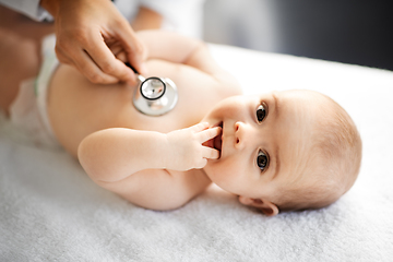 Image showing doctor with stethoscope listening to baby patient