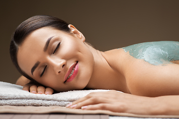 Image showing woman with blue clay mask in spa