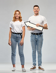 Image showing happy couple in white t-shirts with arrow to left