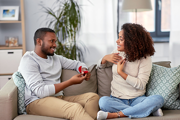 Image showing african american man giving woman engagement ring