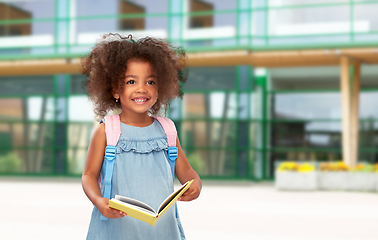 Image showing happy little african girl with book and backpack