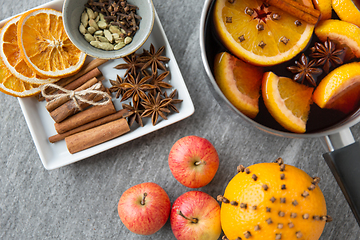 Image showing pot of hot mulled wine, orange, apples and spices