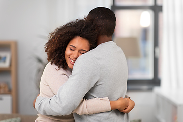 Image showing happy african american couple hugging at home