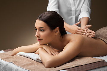Image showing woman lying and having back massage at spa