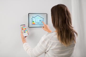 Image showing woman using tablet computer and smartphone