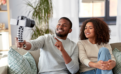 Image showing couple of video bloggers with camera at home