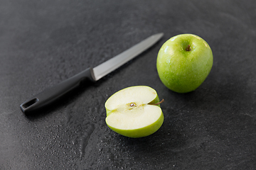 Image showing green apples and kitchen knife on slate background