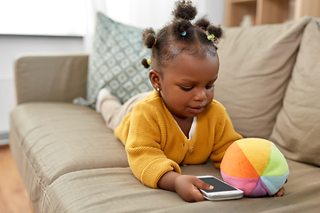 Image showing african american baby girl with smartphone at home