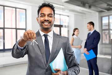 Image showing indian man realtor with keys at empty office room