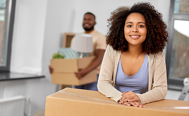 Image showing happy couple with boxes moving to new home