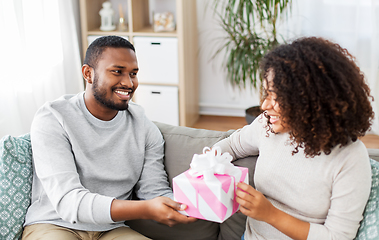 Image showing happy couple with gift at home