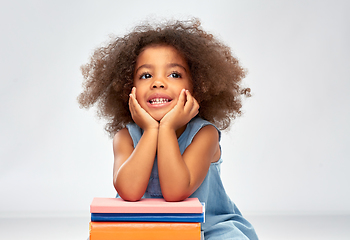 Image showing smiling little african american girl with books