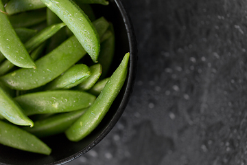 Image showing peas in bowl on wet slate stone background