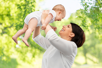 Image showing happy middle-aged mother with little baby daughter