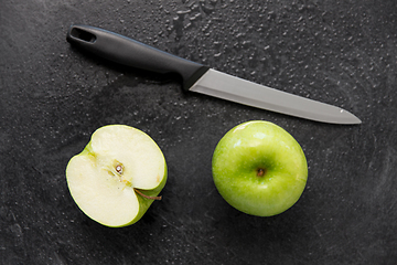 Image showing green apples and kitchen knife on slate background