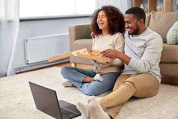 Image showing happy african american couple eating pizza at home