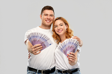 Image showing happy couple in white t-shirts with euro money