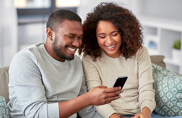 Image showing african american couple with smartphone at home