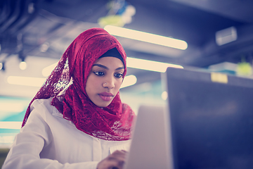 Image showing black muslim business woman ,working on laptop computer