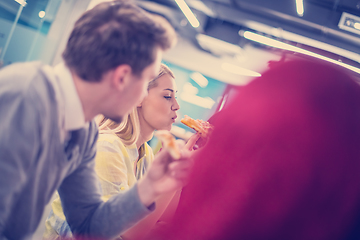 Image showing multiethnic business team eating pizza