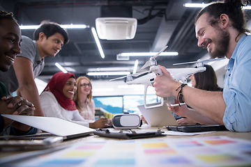 Image showing multiethnic business team learning about drone technology