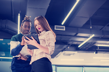 Image showing multiethnic business couple using a tablet computer