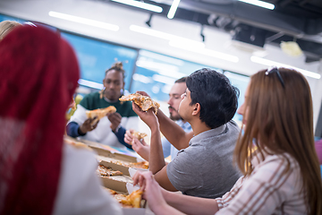 Image showing multiethnic business team eating pizza