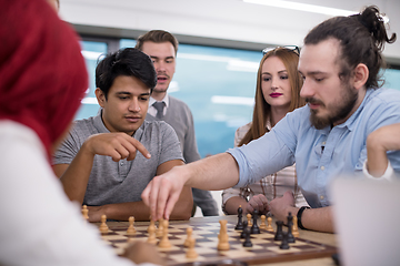 Image showing multiethnic group of business people playing chess