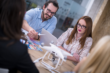 Image showing multiethnic business team learning about drone technology