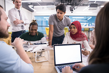 Image showing multiethnic business team learning about drone technology