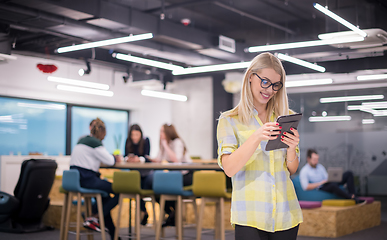 Image showing blonde businesswoman working online using digital tablet