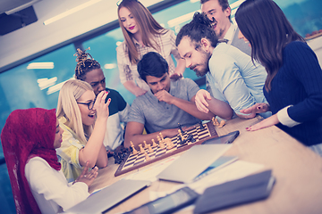 Image showing multiethnic group of business people playing chess