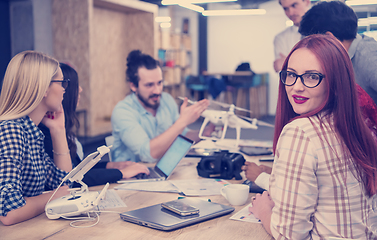 Image showing redhead business woman learning about drone technology