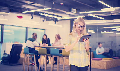 Image showing blonde businesswoman working online using digital tablet