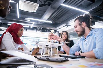 Image showing multiethnic business team learning about drone technology