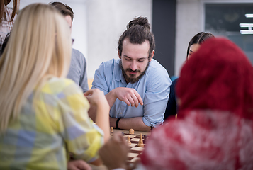 Image showing multiethnic group of business people playing chess