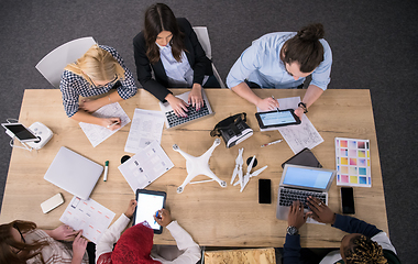 Image showing top view of multiethnic business team learning about drone techn